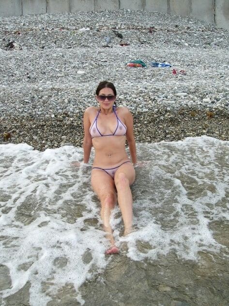 Amateur brunette wife in transparent bikini on the beach