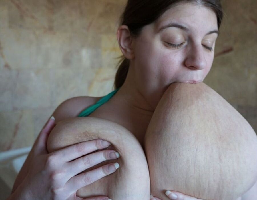 Sarah loves sucking her own nipples