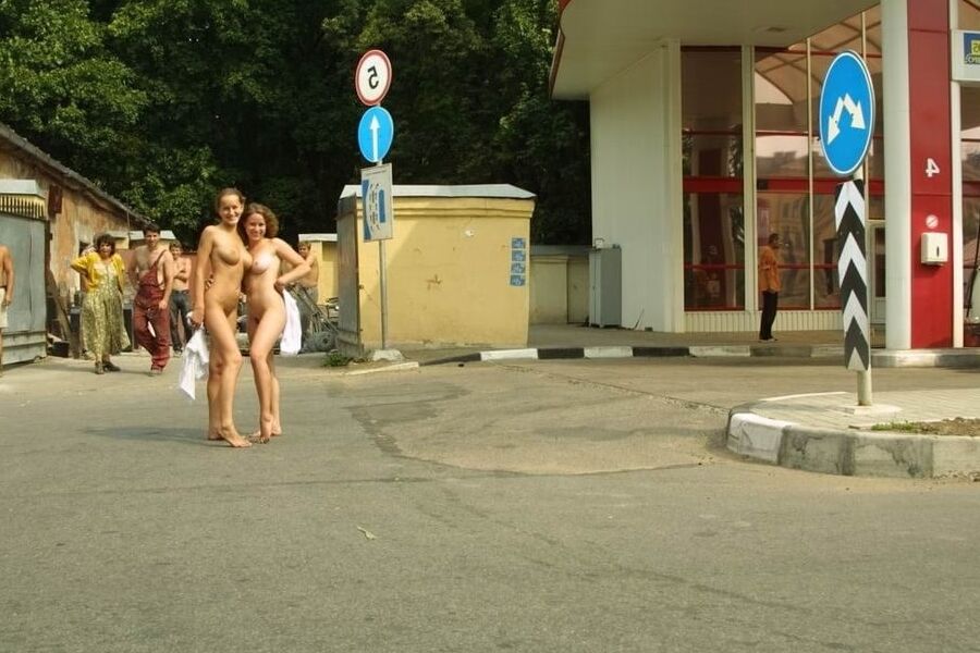 Two blondes posing absolutely naked at very public places