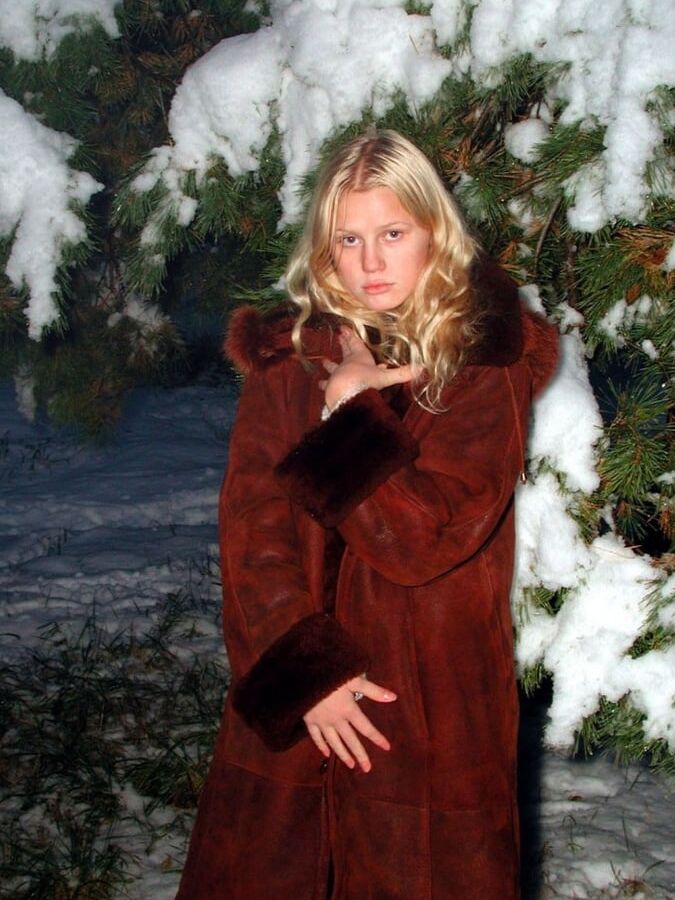 Nice blonde in fur coat posing