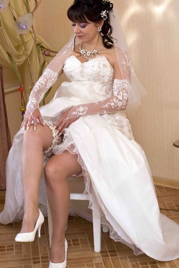Attractive Eastern European bride wearing tan stockings