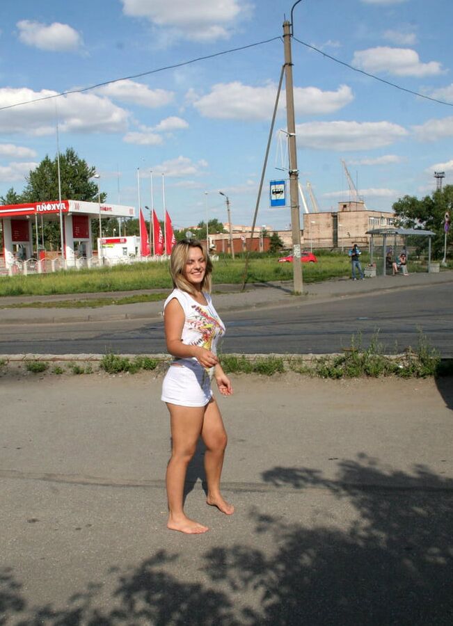 Girl with big boobs undressing near gas station