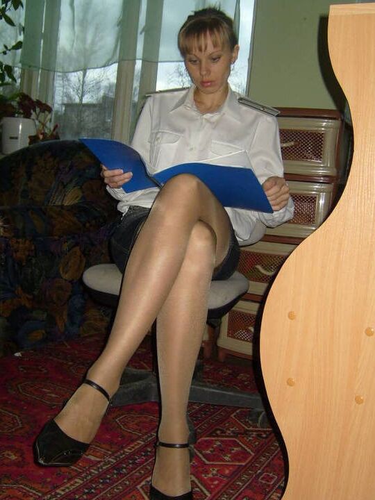 Russian slim lady with long legs wearing shiny tan stockings