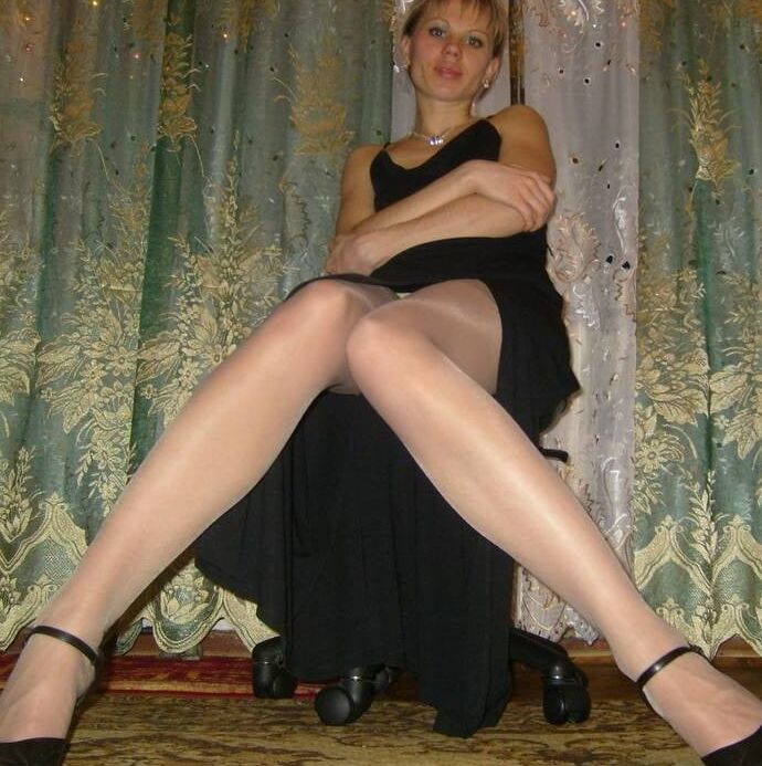 Russian slim lady with long legs wearing shiny tan stockings