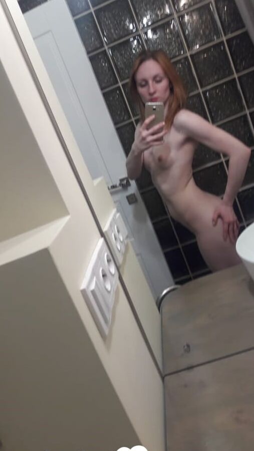 Skinny redhead with small tits in the mirror