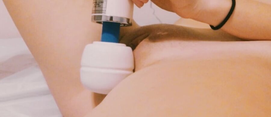 Slut masturbates her wet clit with a vibrator. Close-up.