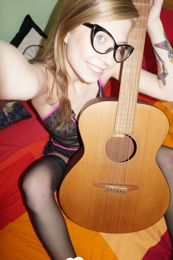 Cute nerdy guitarist posing in some lingerie