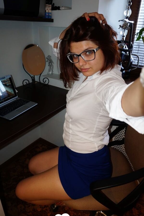 Hot nerdy babe taking some pics after class