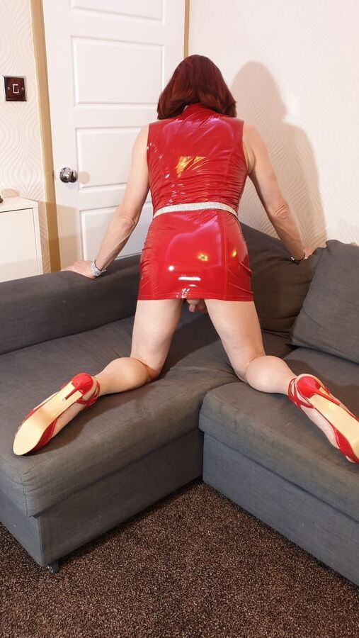 Sissy Lucy wanking her big cock in red PVC mini dress