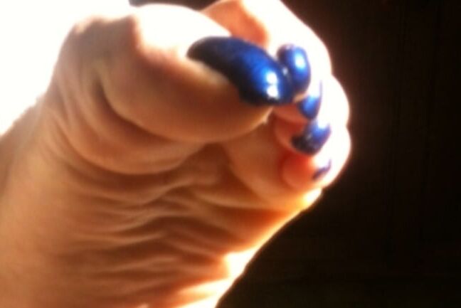 Blue toenails under sun ray
