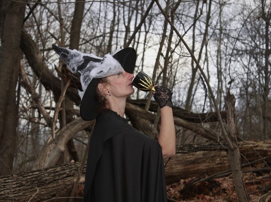 Witch with broom in forest