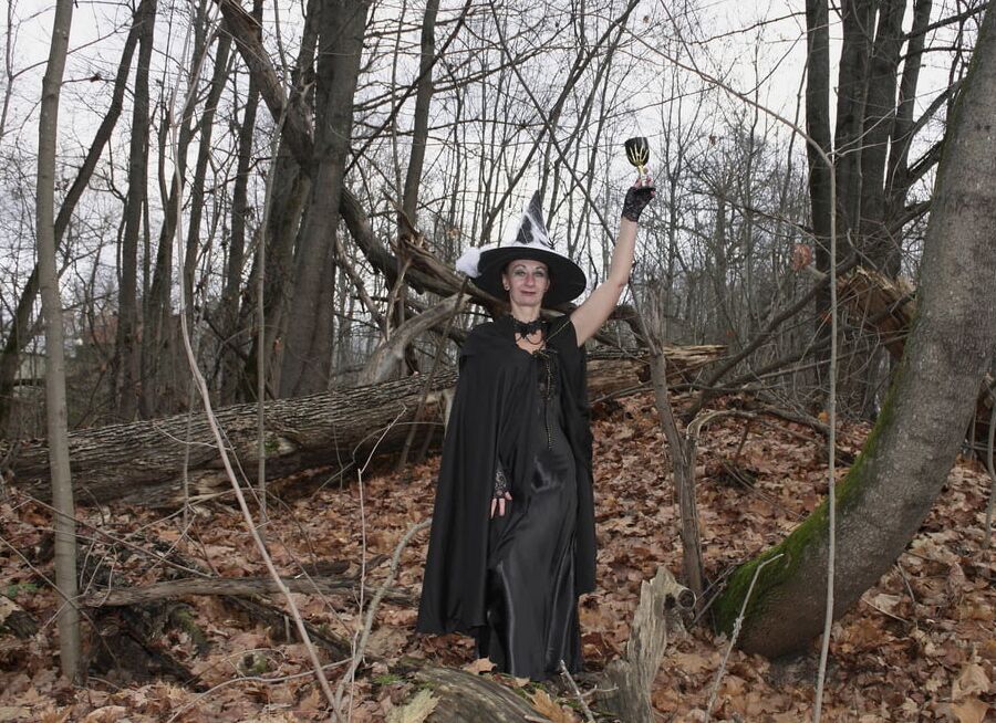 Witch with broom in forest