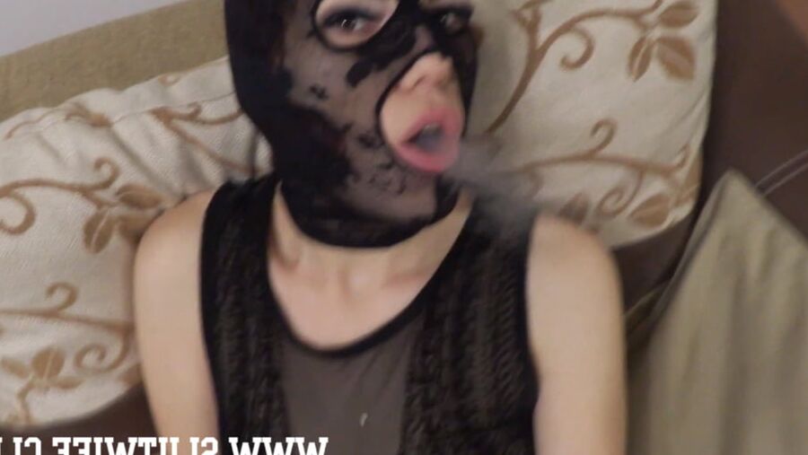 Masked slut smokes a cigarette and gets jerked on her face