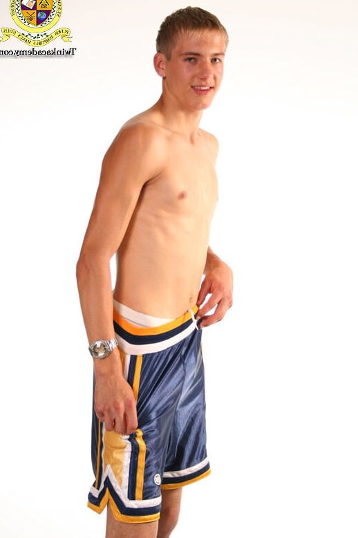 Blond teenage Latvian hunk poses in his basketball uniform