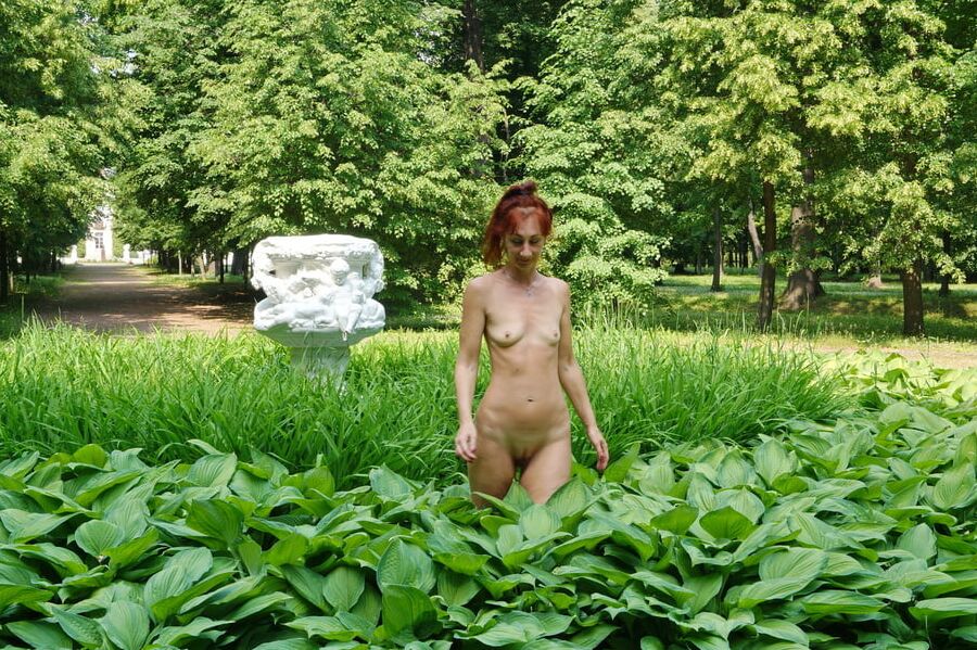 Naked in the grass by the vase