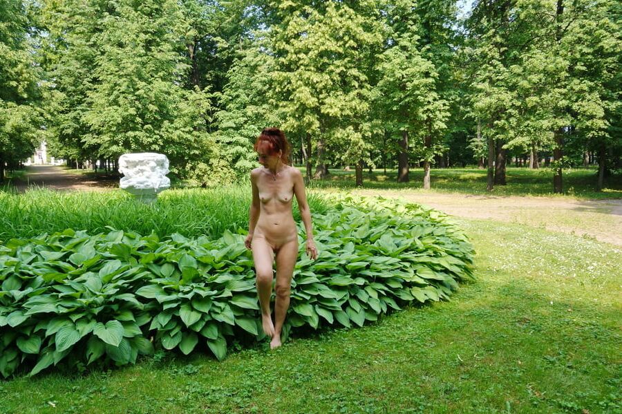 Naked in the grass by the vase