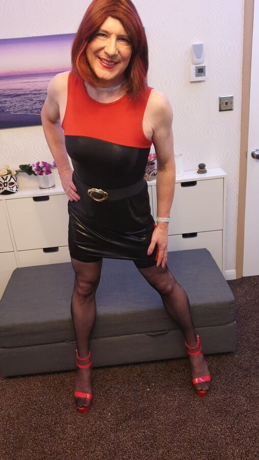 TGirl Lucy posing and playing in black and red bodycon dress