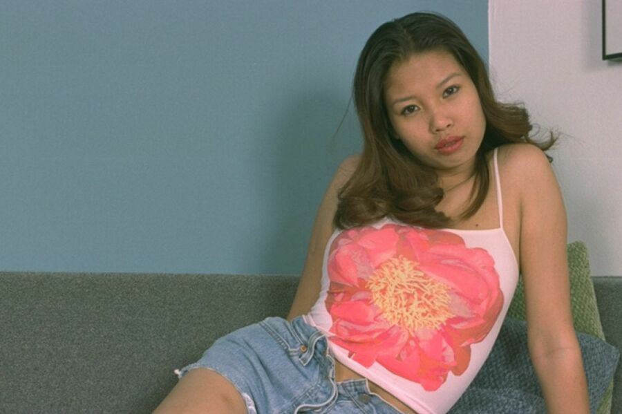 asian ts warms up on her sofa... .