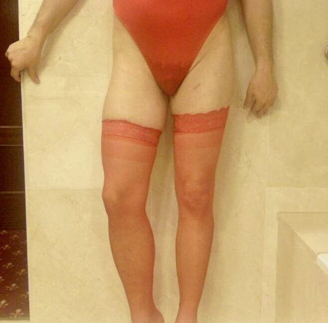 Wetting myself in my red body and stockings oops!