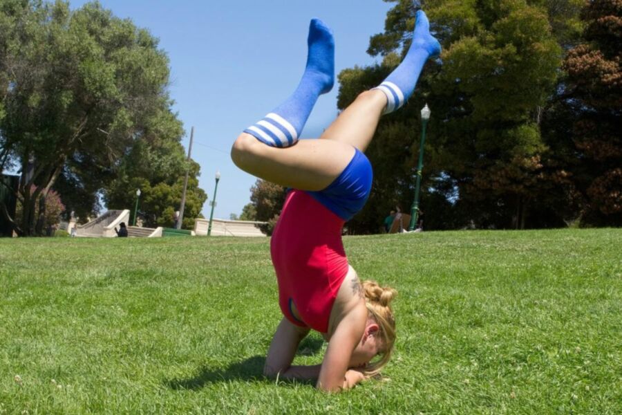 Flexible Red Gymnast Girl in fishnet suit and a guy on trunk