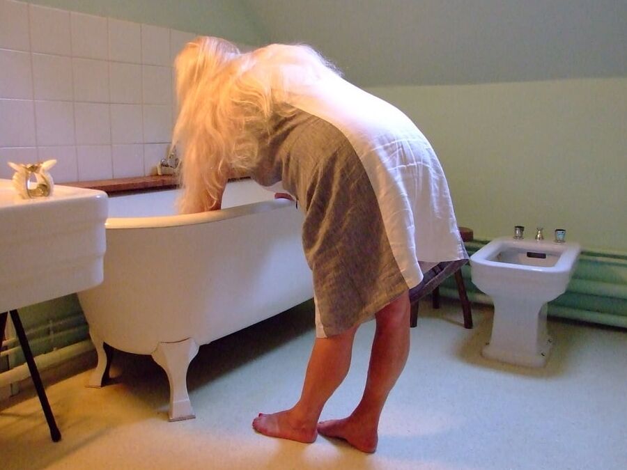 Blonde GILF takes bath