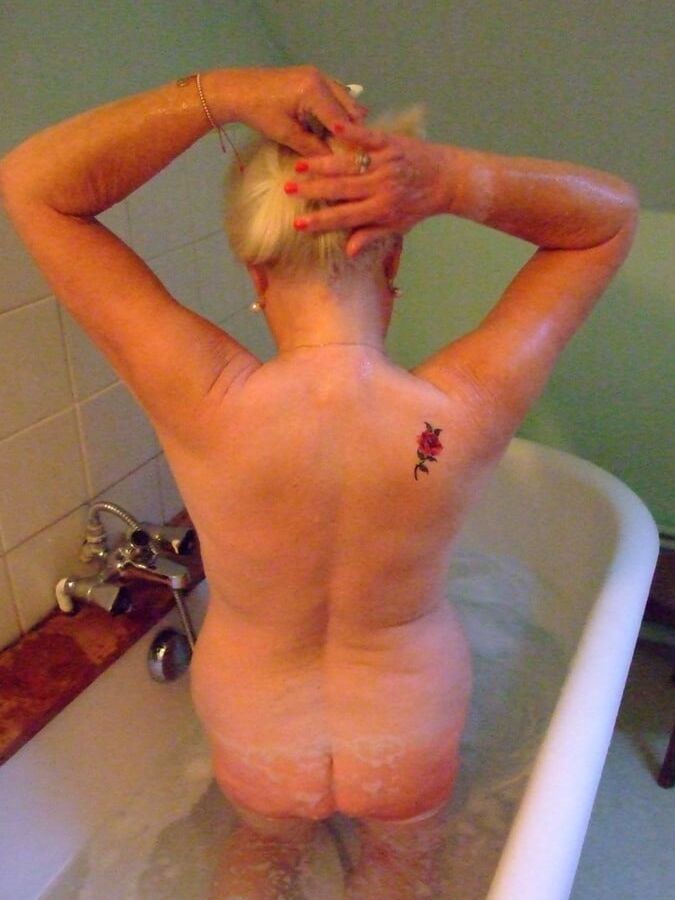 Blonde GILF takes bath