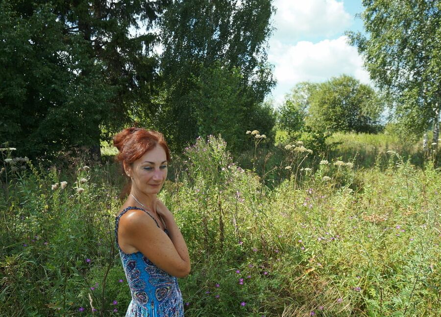 In blue dress in field