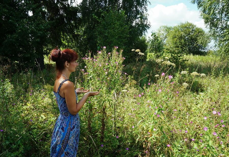 In blue dress in field