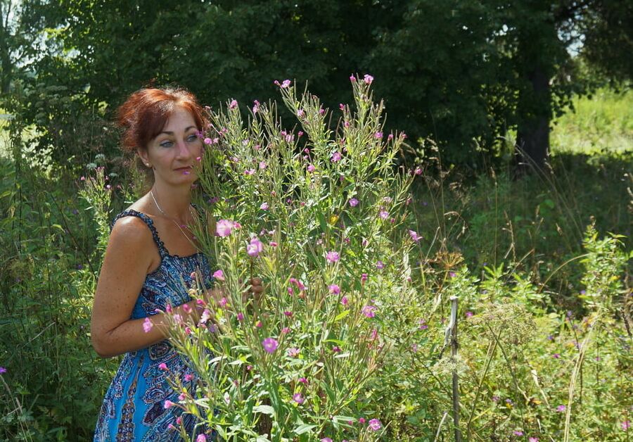 In blue dress in field