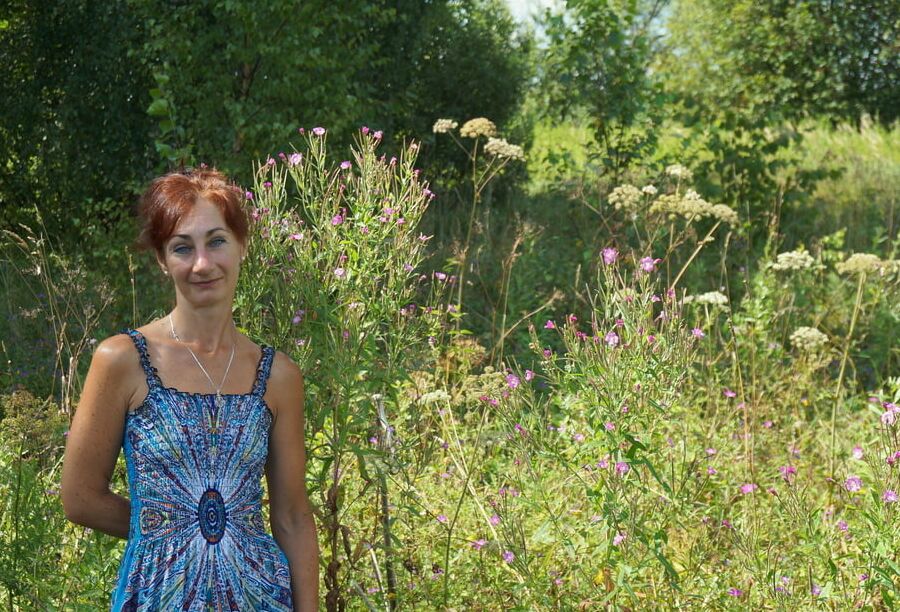 In blue dress in field