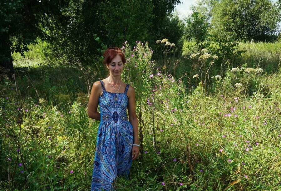 In blue dress in field