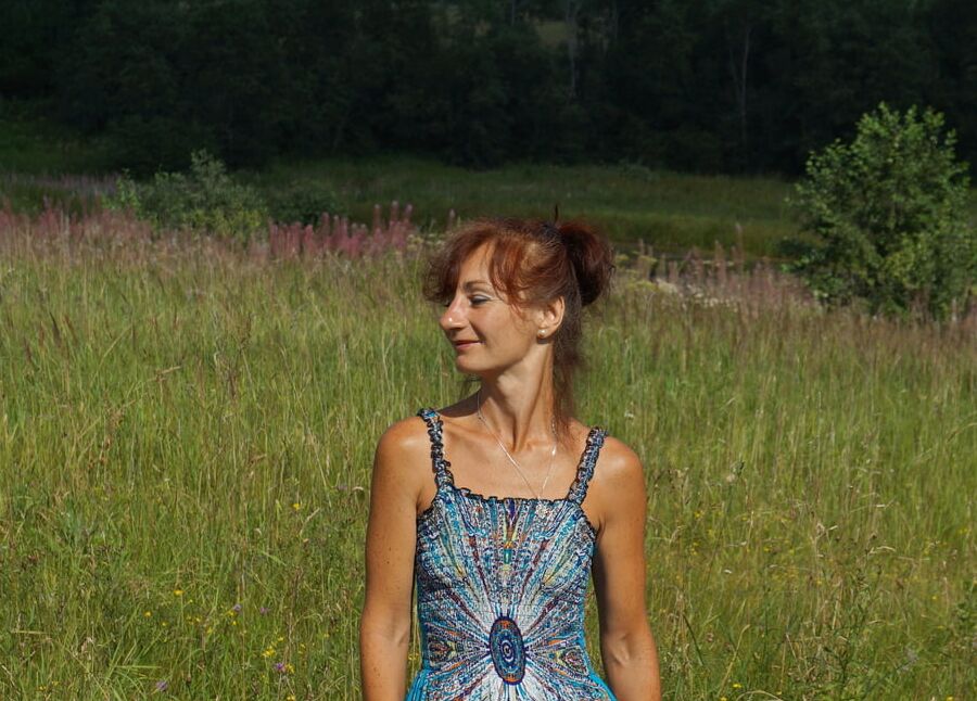 In blue dress in field