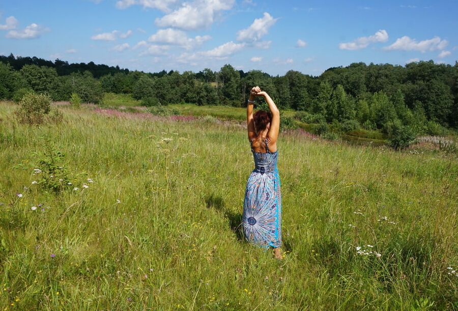 In blue dress in field