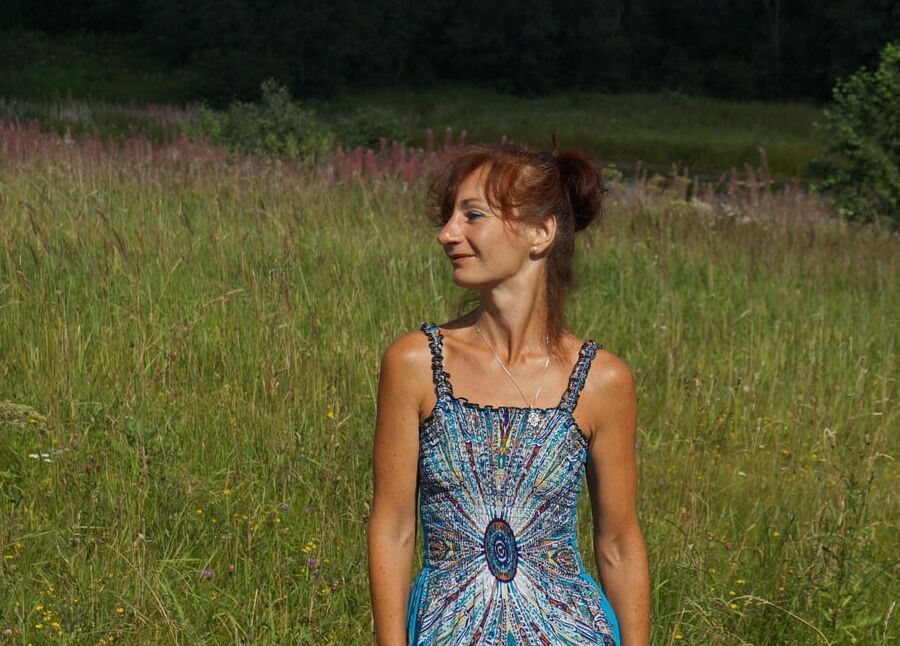 In blue dress in field
