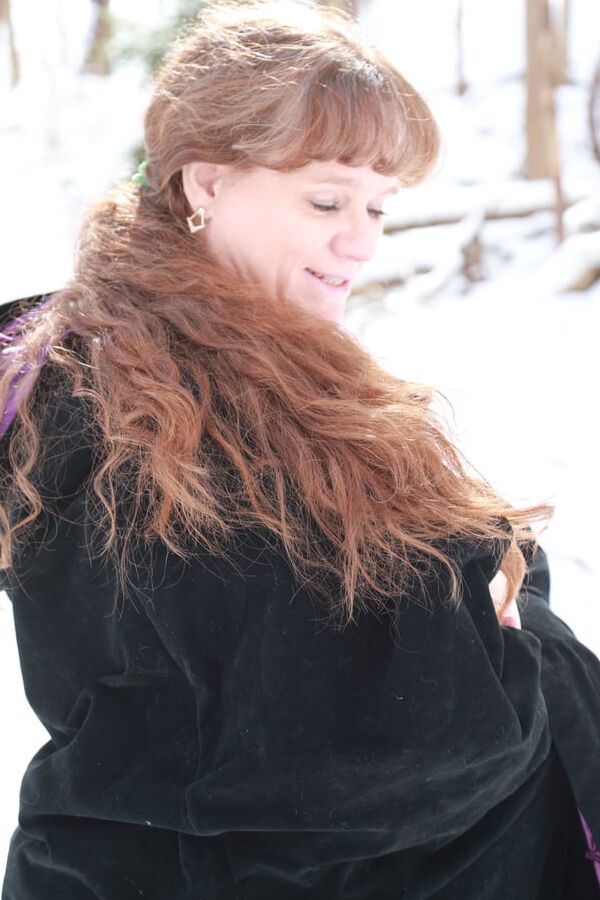 Sally in black cape in winter