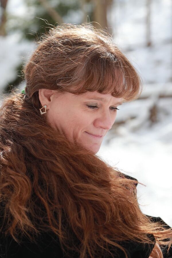 Sally in black cape in winter