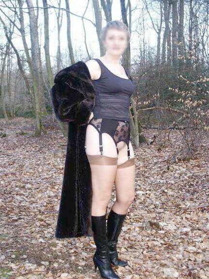 Mature in fur coat posing