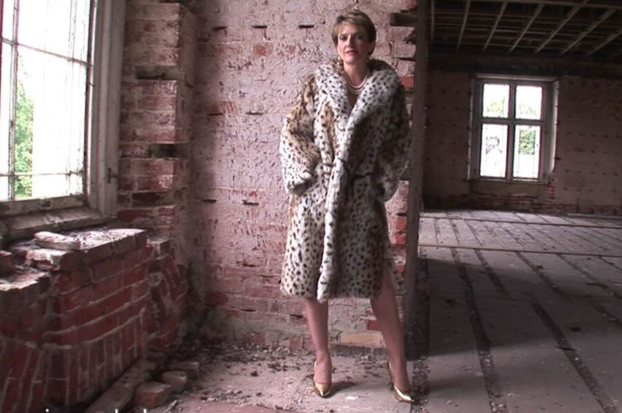 Mature in fur coat posing