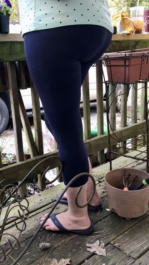 Mature wife Rose gardening in spandex pantyline