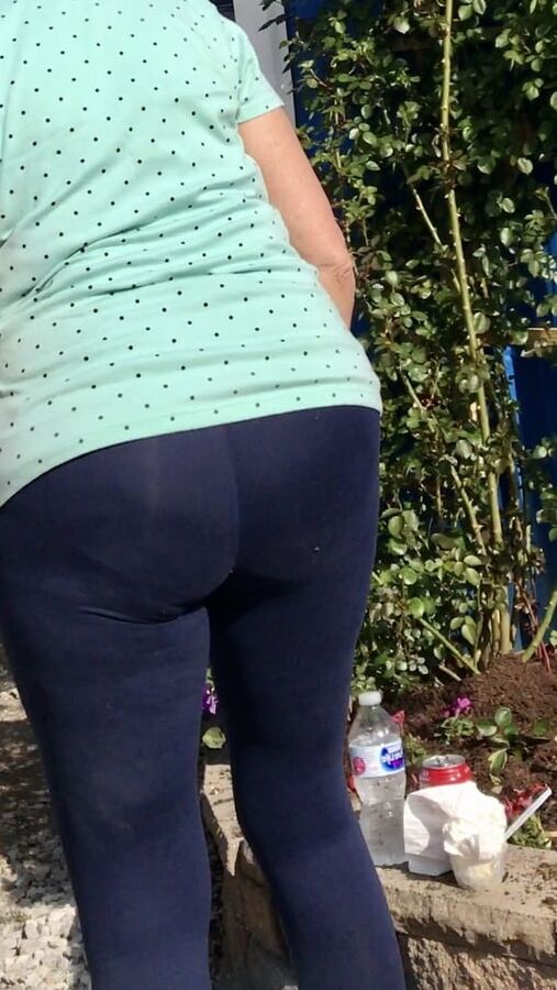 Mature wife Rose gardening in spandex pantyline