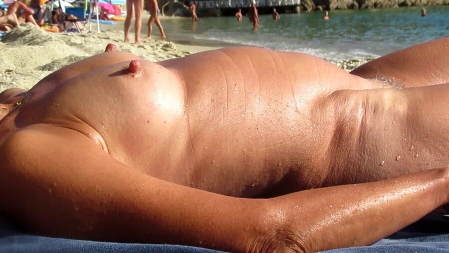 Hanging, saggy, floppy Nipples at beach