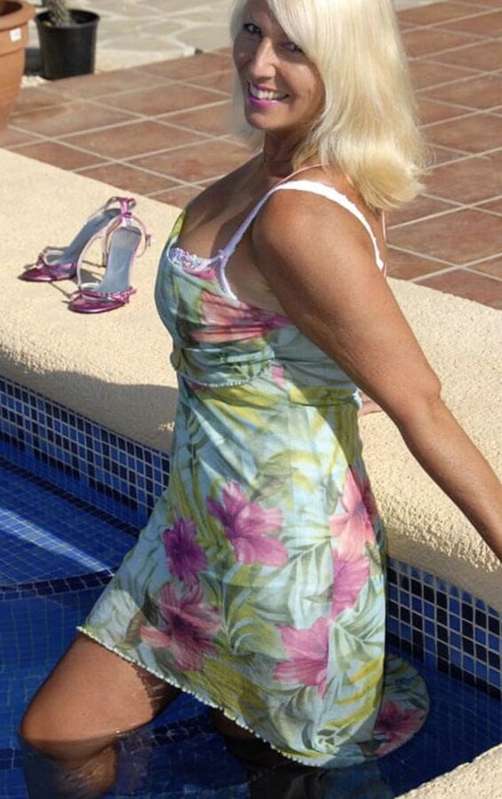 Sandy dips in the pool in summer dress