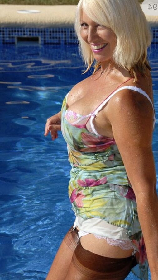 Sandy dips in the pool in summer dress