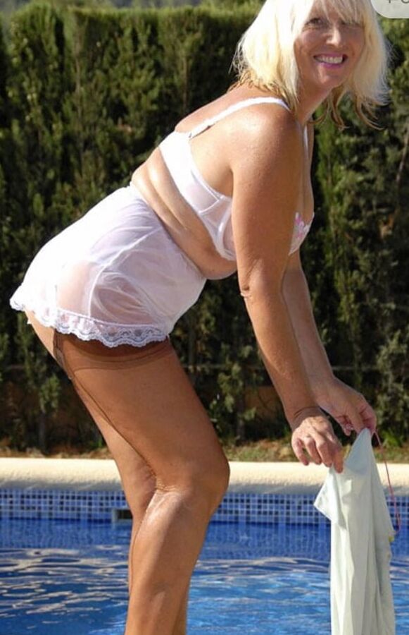 Sandy dips in the pool in summer dress