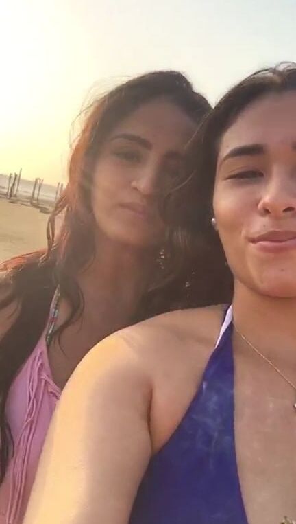 Smoking Kelly Cuesta on beach with lez gf