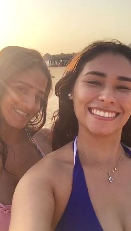 Smoking Kelly Cuesta on beach with lez gf