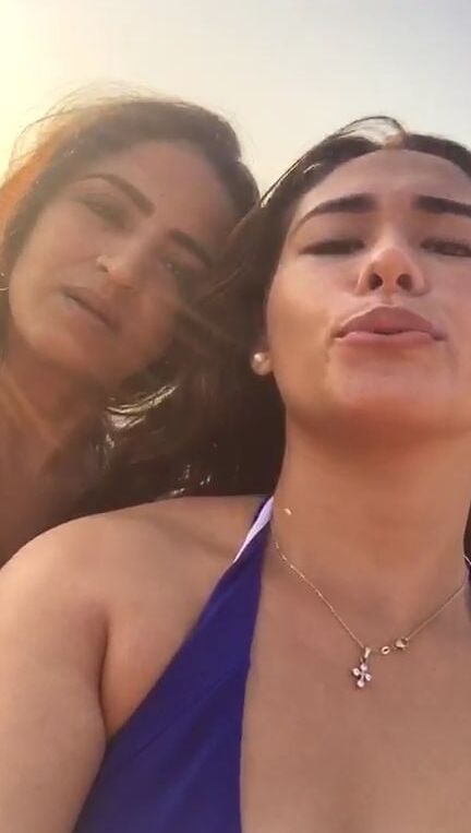 Smoking Kelly Cuesta on beach with lez gf