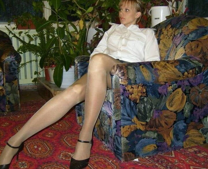 Russian slim lady with long legs wearing shiny tan stockings
