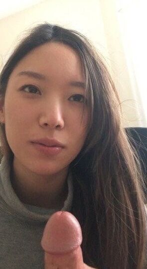 Asian girl gives blowjob