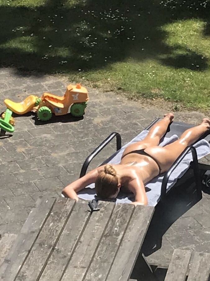 Hot girl getting taned in the yard